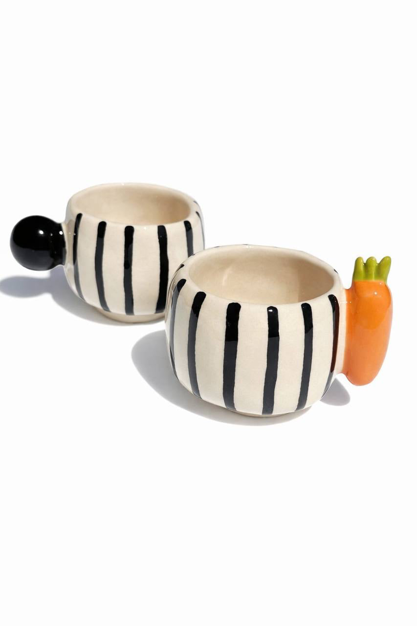 Conjunto de café entre cenoura e pom-pom